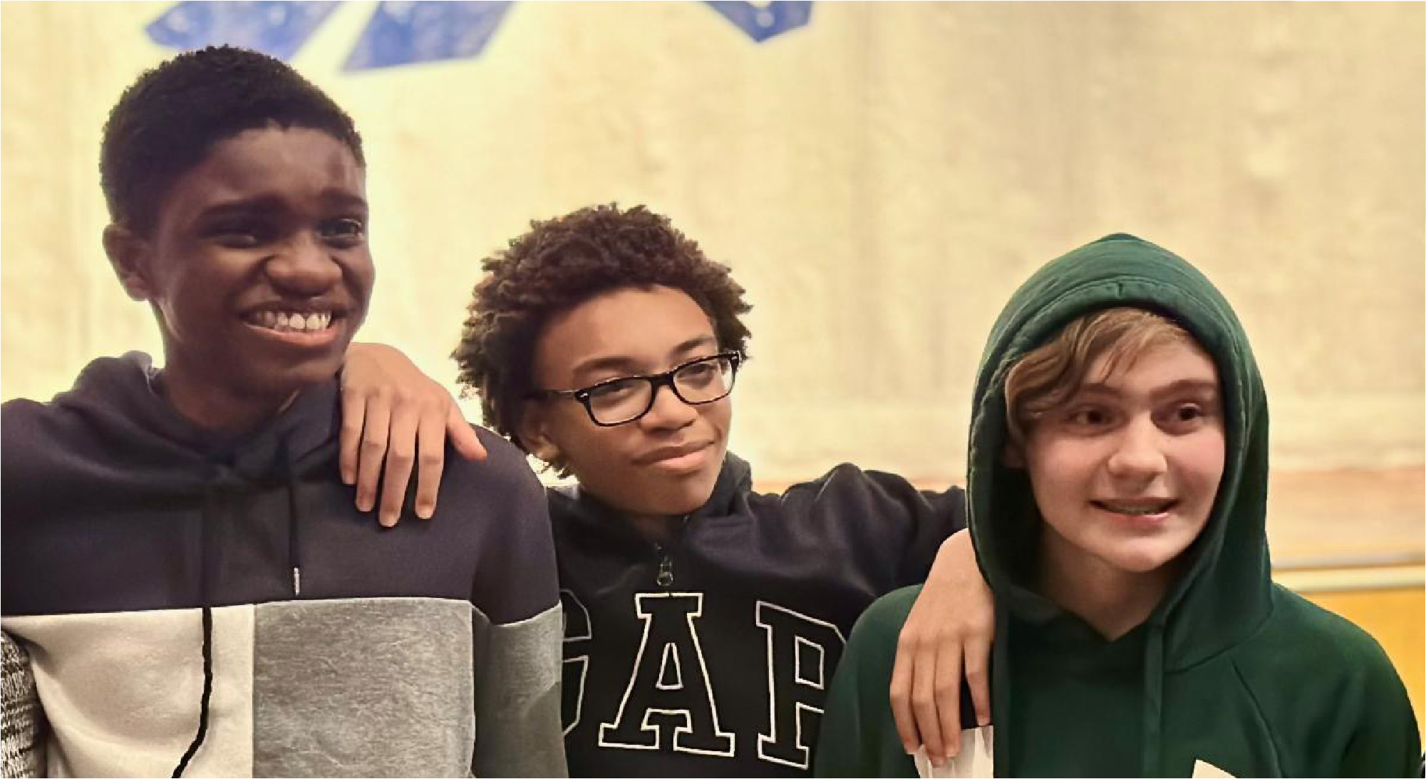 Three students smiling together after a HERC Holocaust education program.