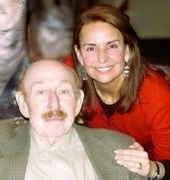 Louise Jesse embracing her father, a Holocaust survivor, smiling together