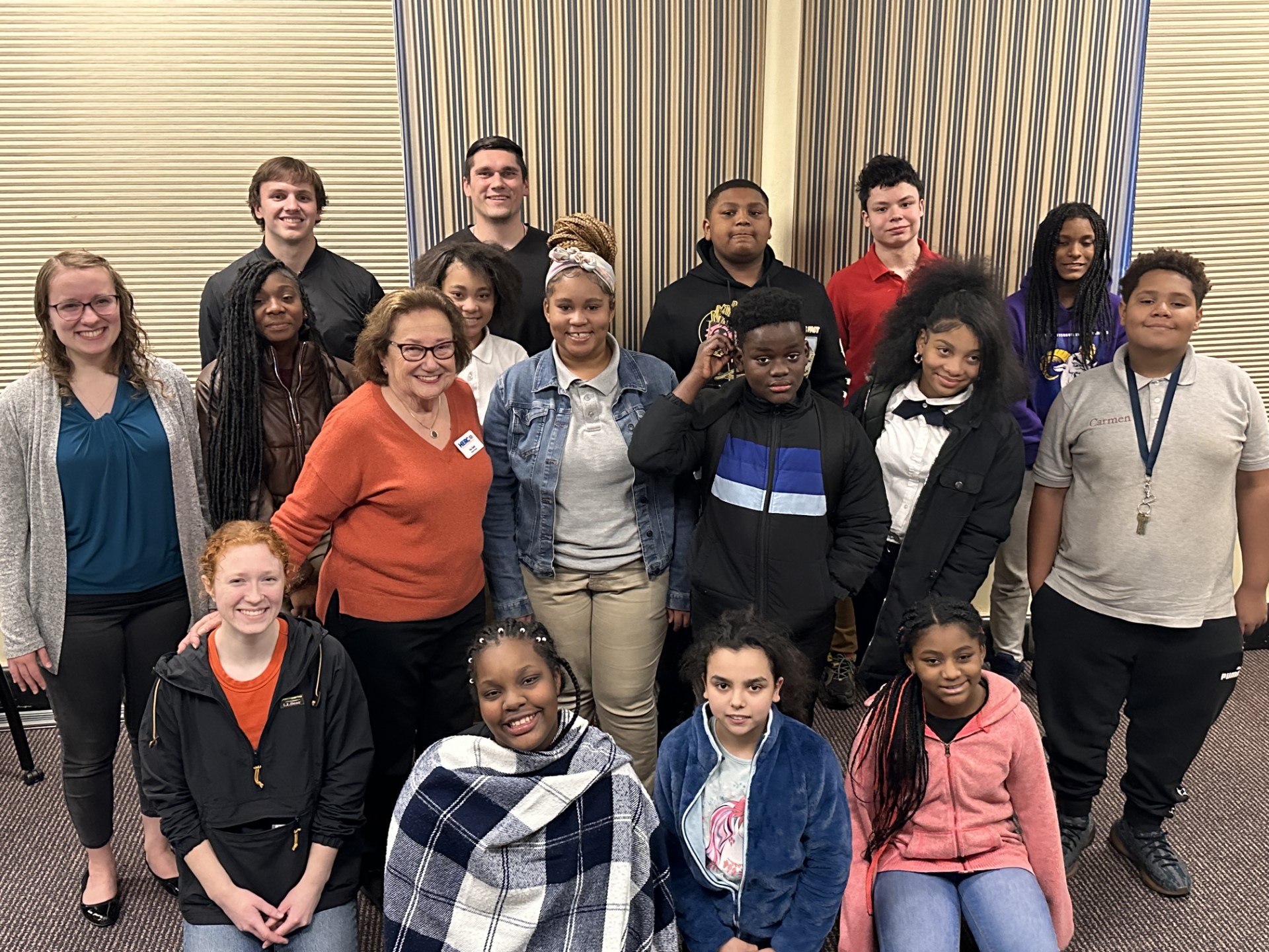 Holocaust survivor Eva Zaret poses with a group of students and educators after a classroom presentation.