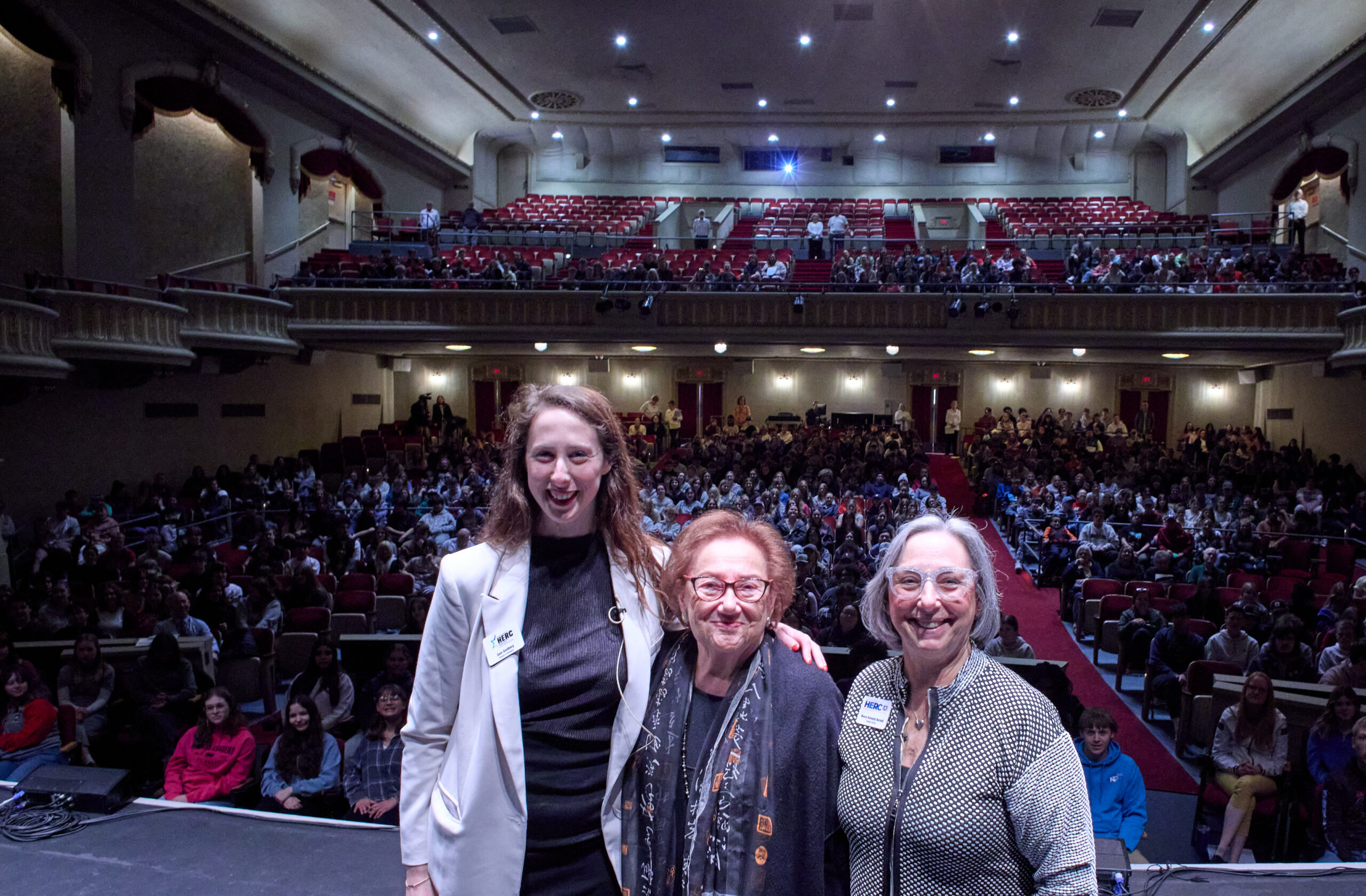 HERC Education Director Sam Goldberg with Speakers Bureau members Holocaust survivor Eva Zaret and Nancy Kennedy Barnett at an event organized by a HERC fellow, reaching over 800 students in a packed auditorium