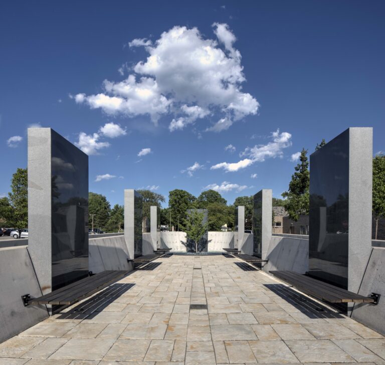 Pinat Hatikvah (Corner of Hope), HERC's outdoor Holocaust memorial at Milwaukee Jewish Federation's campus in Whitefish Bay, featuring modern architectural design with tall pillars, reflecting panels, and benches creating a contemplative space dedicated to life after the Holocaust