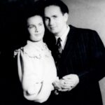 Black-and-white portrait of Holocaust survivors Dora and Shimon Russek, a couple posed closely together.