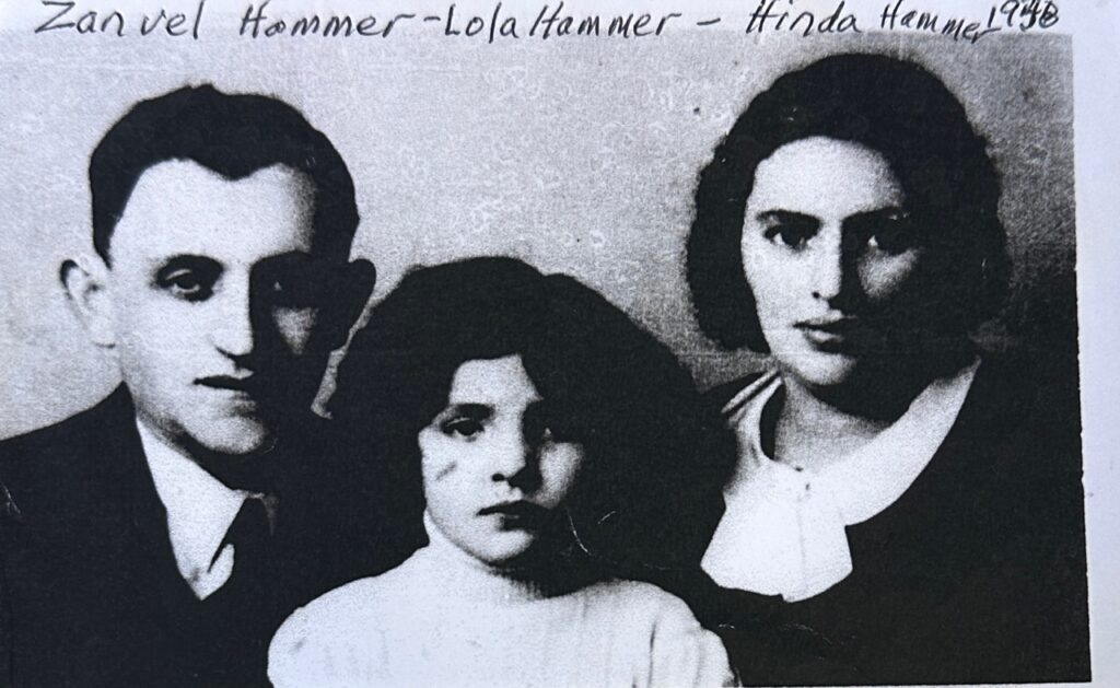 A couple and their young daughter pose for a picture.