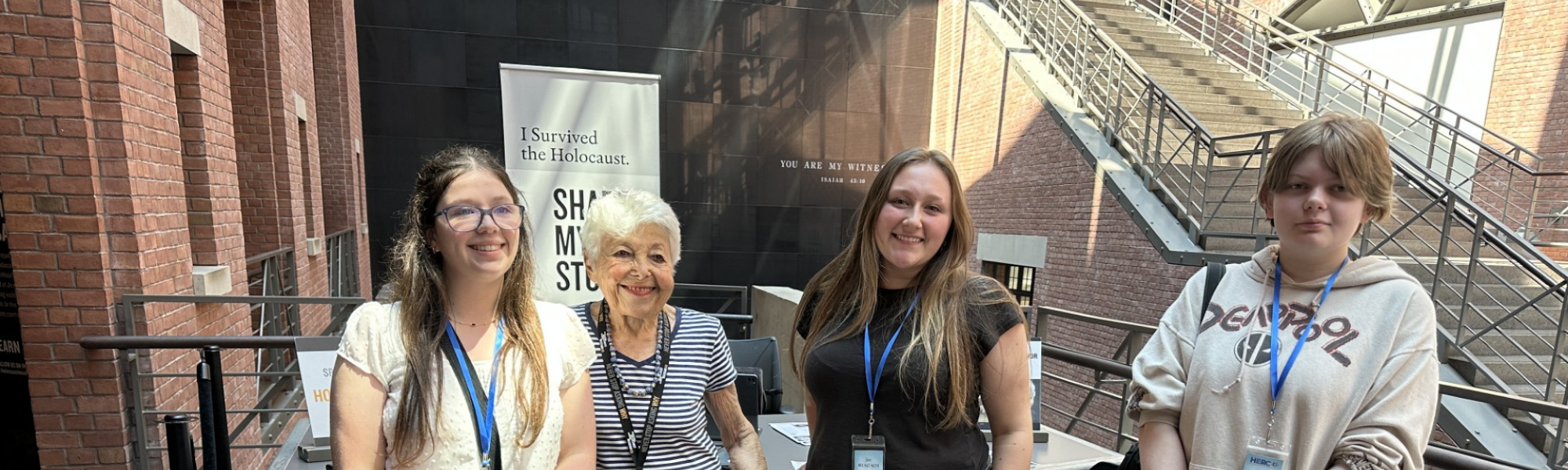 Students pose with elderly woman